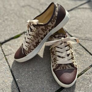 Michael Kors City sneakers in a brown signature logo canvas with leather trim.